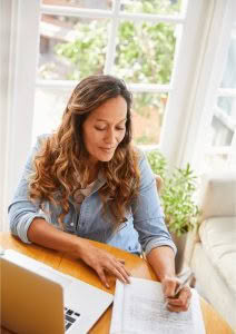 Woman writing in a journal image